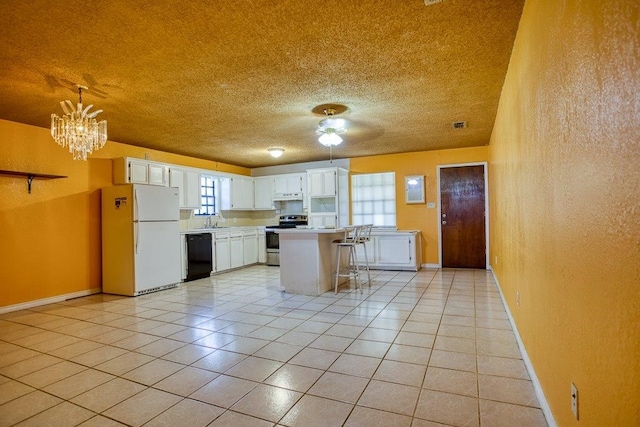 kitchen with stainless steel electric range, dishwasher, a kitchen island, white fridge, and white cabinetry