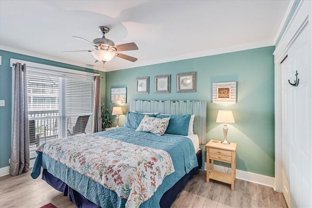 bedroom with a closet, ceiling fan, and light hardwood / wood-style flooring