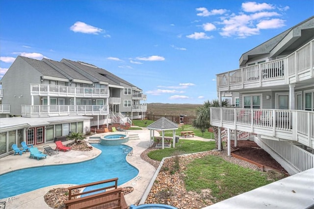 view of pool with a gazebo, a patio, and an in ground hot tub