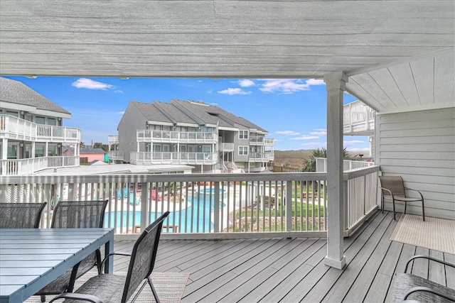 wooden terrace with a fenced in pool