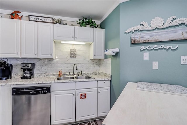 kitchen featuring tasteful backsplash, white cabinets, sink, and dishwasher