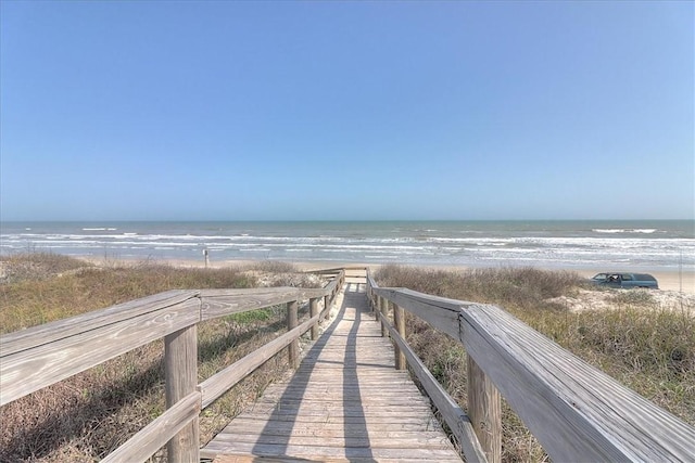 view of home's community featuring a water view and a view of the beach