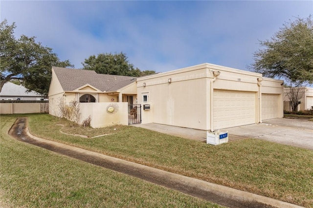 view of front of home featuring an attached garage, fence private yard, and stucco siding