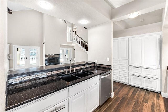 kitchen featuring french doors, sink, white cabinetry, dark hardwood / wood-style flooring, and dishwasher