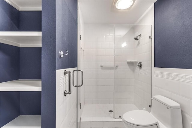 bathroom with walk in shower, toilet, tile walls, and crown molding