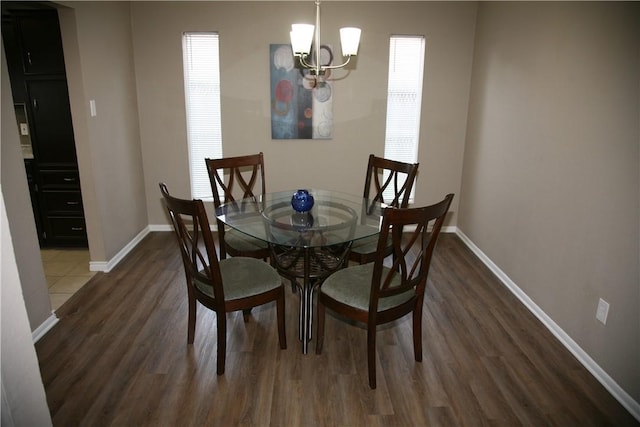 dining room with a chandelier and dark hardwood / wood-style flooring