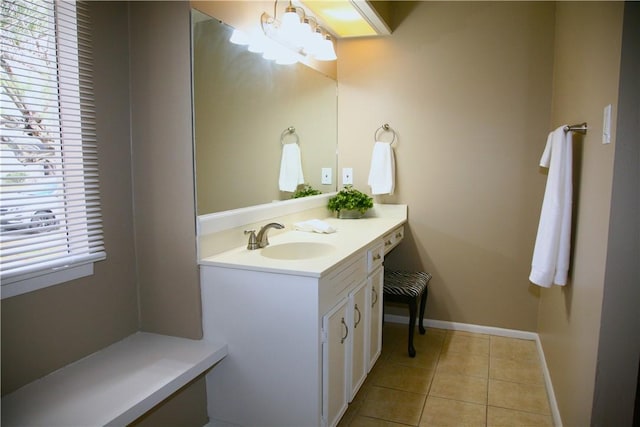 bathroom featuring tile patterned flooring, vanity, and an inviting chandelier