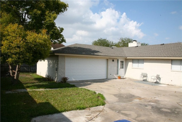 single story home featuring a front lawn and a garage