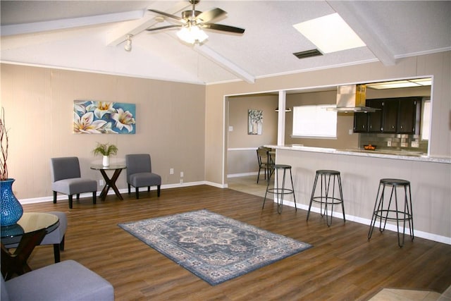 living room with a textured ceiling, vaulted ceiling with beams, ceiling fan, and dark wood-type flooring