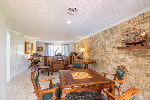 carpeted dining space featuring a textured ceiling and crown molding