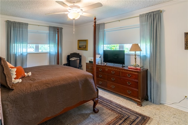 bedroom with ceiling fan, a textured ceiling, carpet floors, and crown molding