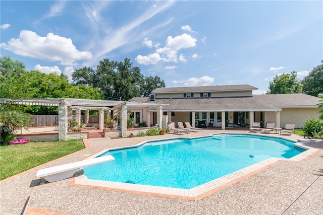 view of pool with a patio, a pergola, and a diving board