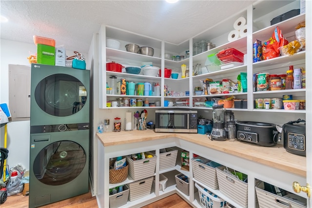 pantry with stacked washer and dryer