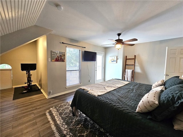 bedroom featuring lofted ceiling, ceiling fan, wood finished floors, and baseboards