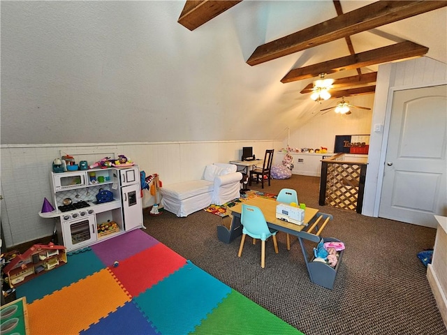 recreation room featuring carpet, wainscoting, ceiling fan, and lofted ceiling with beams