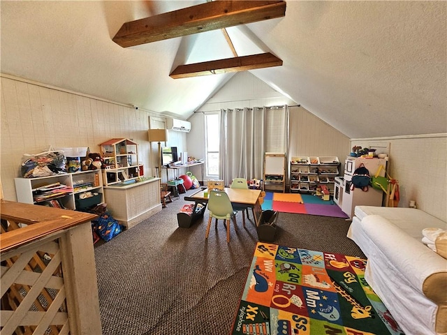 playroom with a wall unit AC, a textured ceiling, lofted ceiling with beams, and carpet flooring