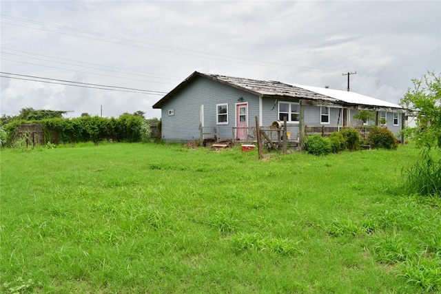 back of property featuring a lawn