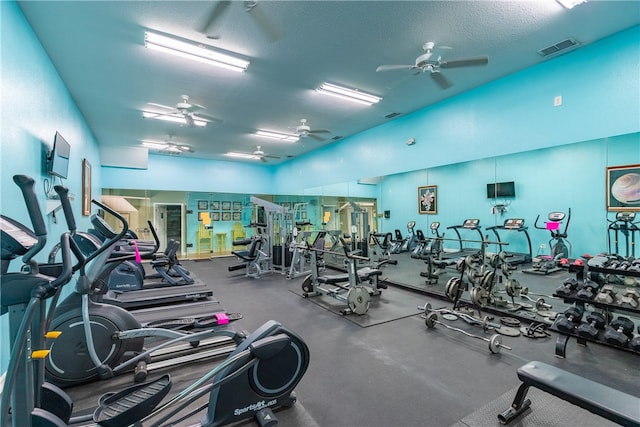 gym with ceiling fan and a textured ceiling