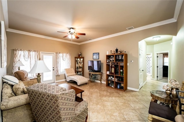 living room with ceiling fan, a healthy amount of sunlight, and ornamental molding