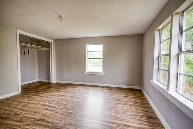 unfurnished bedroom featuring hardwood / wood-style floors and a closet