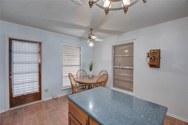 4621 Weiskopf, Corpus Christi, TX 78413 - kitchen featuring ceiling fan, dark countertops, brick patterned flooring, a textured ceiling, and brown cabinets