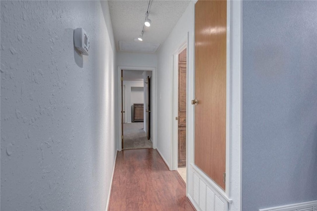 4621 Weiskopf, Corpus Christi, TX 78413 - corridor with track lighting, wood finished floors, a textured wall, and a textured ceiling