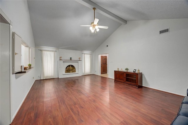 4621 Weiskopf, Corpus Christi, TX 78413 - unfurnished living room featuring ceiling fan, a fireplace, beamed ceiling, wood finished floors, and high vaulted ceiling
