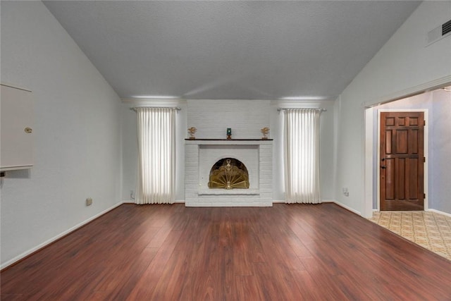 4621 Weiskopf, Corpus Christi, TX 78413 - unfurnished living room with wood finished floors, a fireplace, and lofted ceiling