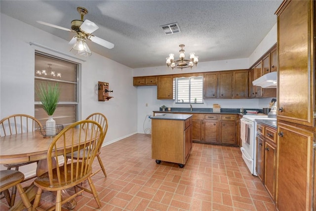 4621 Weiskopf, Corpus Christi, TX 78413 - kitchen with electric stove, under cabinet range hood, brick patterned flooring, a chandelier, and a kitchen island