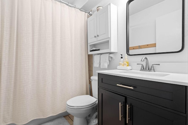 full bath featuring curtained shower, vanity, and toilet