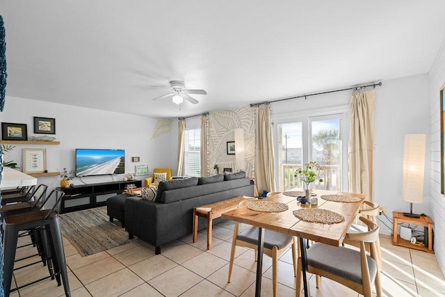 living area with light tile patterned flooring and a ceiling fan