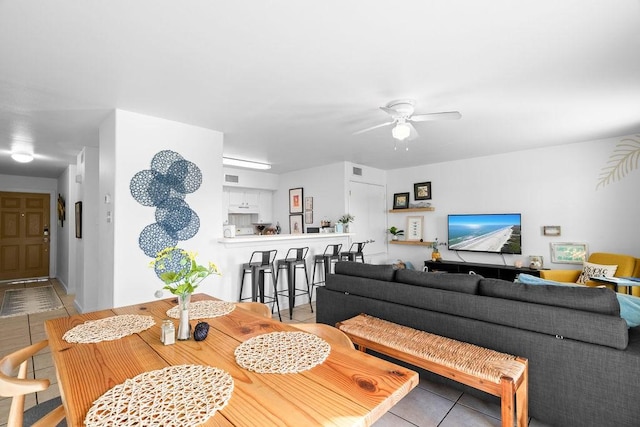 dining space with visible vents, a ceiling fan, and light tile patterned flooring