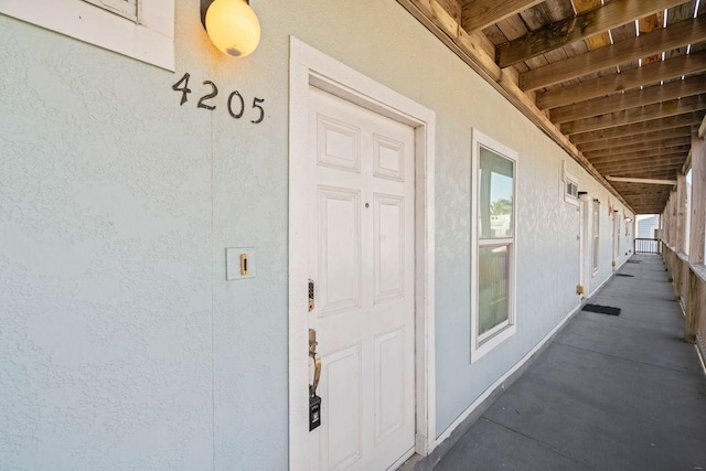 property entrance with stucco siding