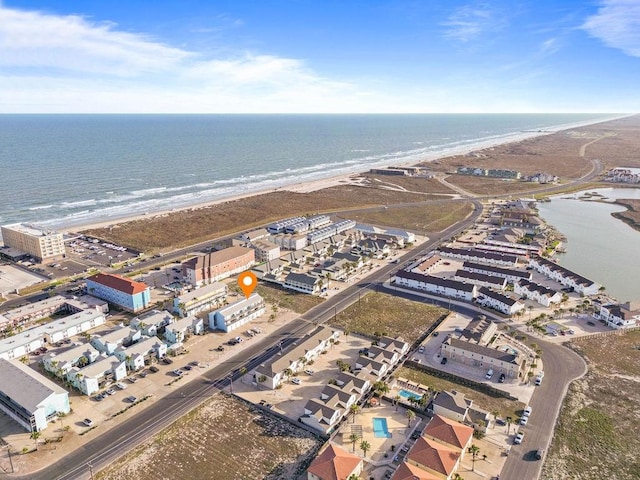 aerial view with a water view and a beach view