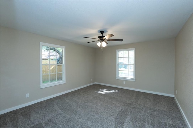 empty room featuring baseboards, ceiling fan, and carpet