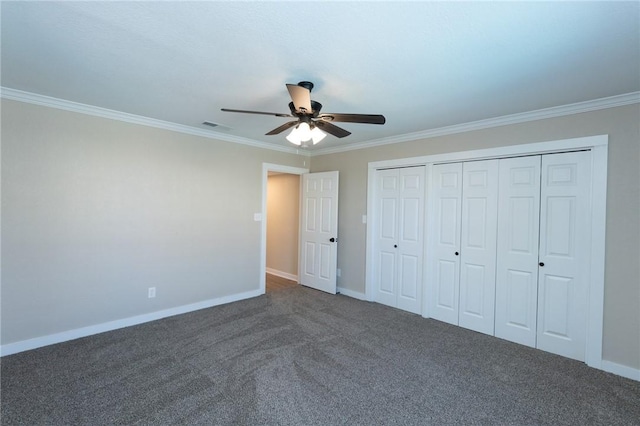 unfurnished bedroom featuring carpet, a closet, baseboards, visible vents, and crown molding