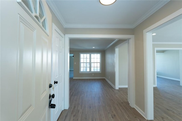 hall with crown molding, wood finished floors, and baseboards
