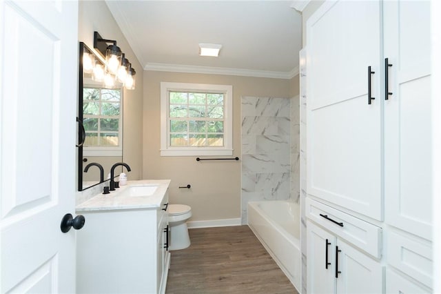 bathroom featuring wood finished floors, toilet, vanity, baseboards, and crown molding