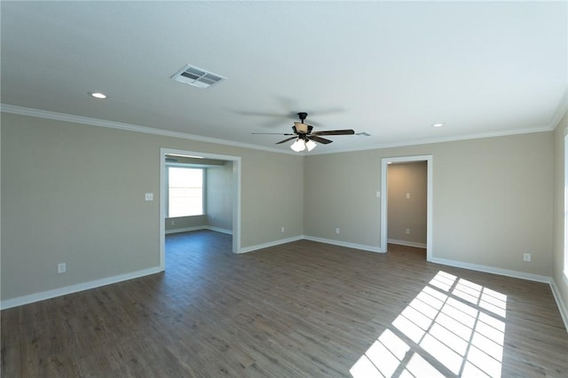 empty room with ornamental molding, visible vents, ceiling fan, and baseboards