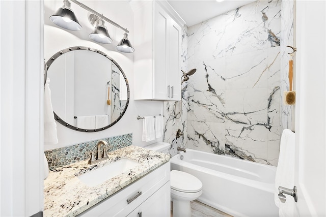 full bathroom with vanity, hardwood / wood-style flooring, toilet, and tiled shower / bath