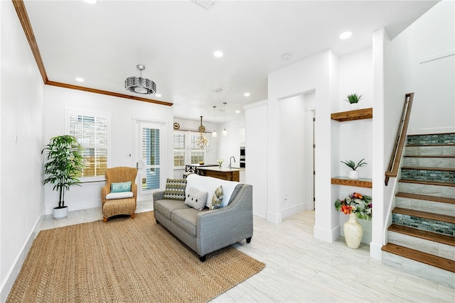 living room featuring crown molding and sink