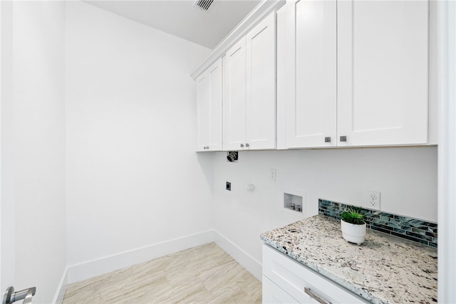 clothes washing area featuring hookup for an electric dryer, cabinets, and hookup for a washing machine