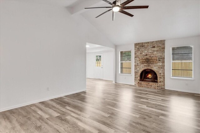 2108 Matagorda Dr, Portland, TX 78374 - unfurnished living room featuring ceiling fan, beamed ceiling, high vaulted ceiling, wood finished floors, and a brick fireplace