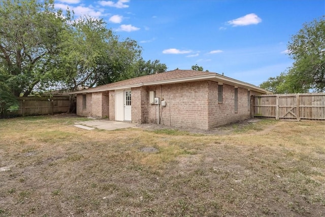 2108 Matagorda Dr, Portland, TX 78374 - back of property featuring a fenced backyard, brick siding, and a patio