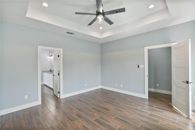 407 Main, Odem, TX 78370 - spare room featuring a raised ceiling, ceiling fan, wood finished floors, and recessed lighting
