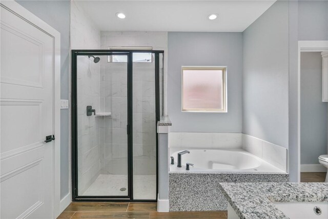 407 Main, Odem, TX 78370 - full bath with a stall shower, a bath, vanity, recessed lighting, and wood finished floors