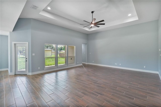 407 Main, Odem, TX 78370 - spare room featuring ceiling fan, a raised ceiling, recessed lighting, and dark wood-style flooring