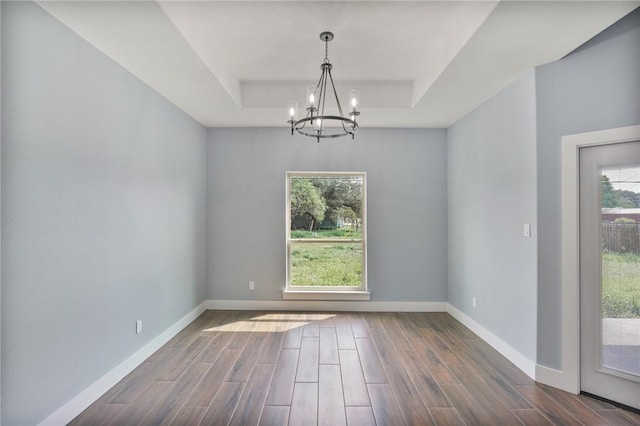 407 Main, Odem, TX 78370 - empty room with a raised ceiling, a chandelier, and dark wood-style flooring
