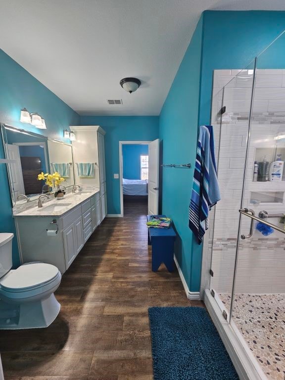 15333 Beaufort Ct, Corpus Christi, TX 78418 - full bath with a shower stall, vanity, wood finished floors, and ensuite bathroom