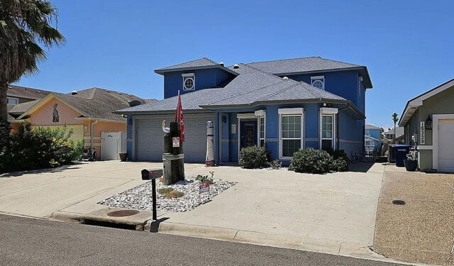15333 Beaufort Ct, Corpus Christi, TX 78418 - view of front of home featuring concrete driveway, a garage, and stucco siding